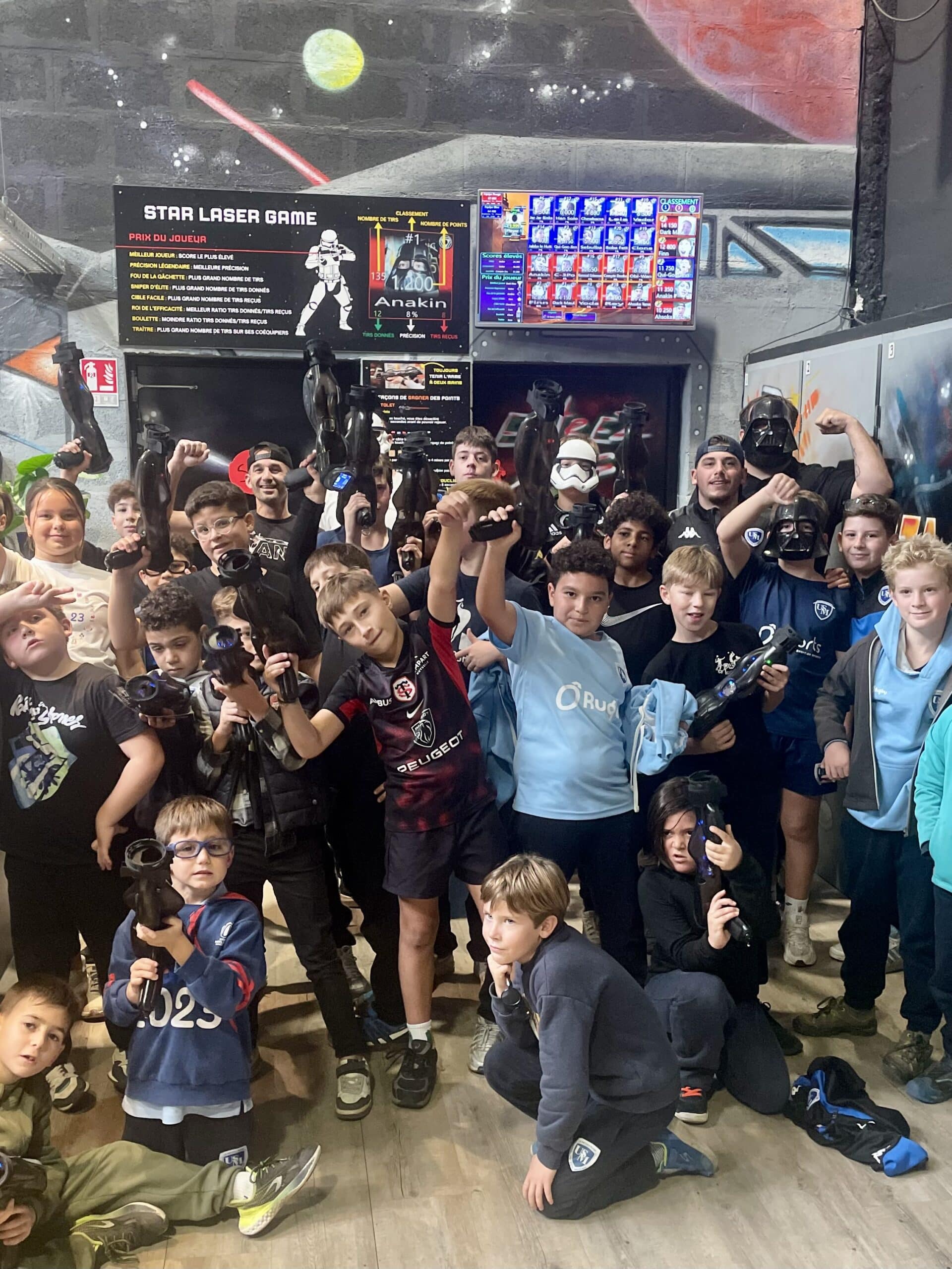 Groupe d'enfants posant avec pistolets laser au Star Laser Game sur le thème Star Wars avec Anakin en tête.